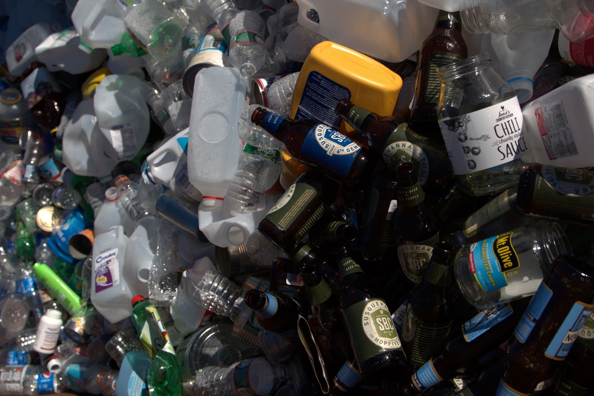 A pile of plastic bottles including a bottle that says 