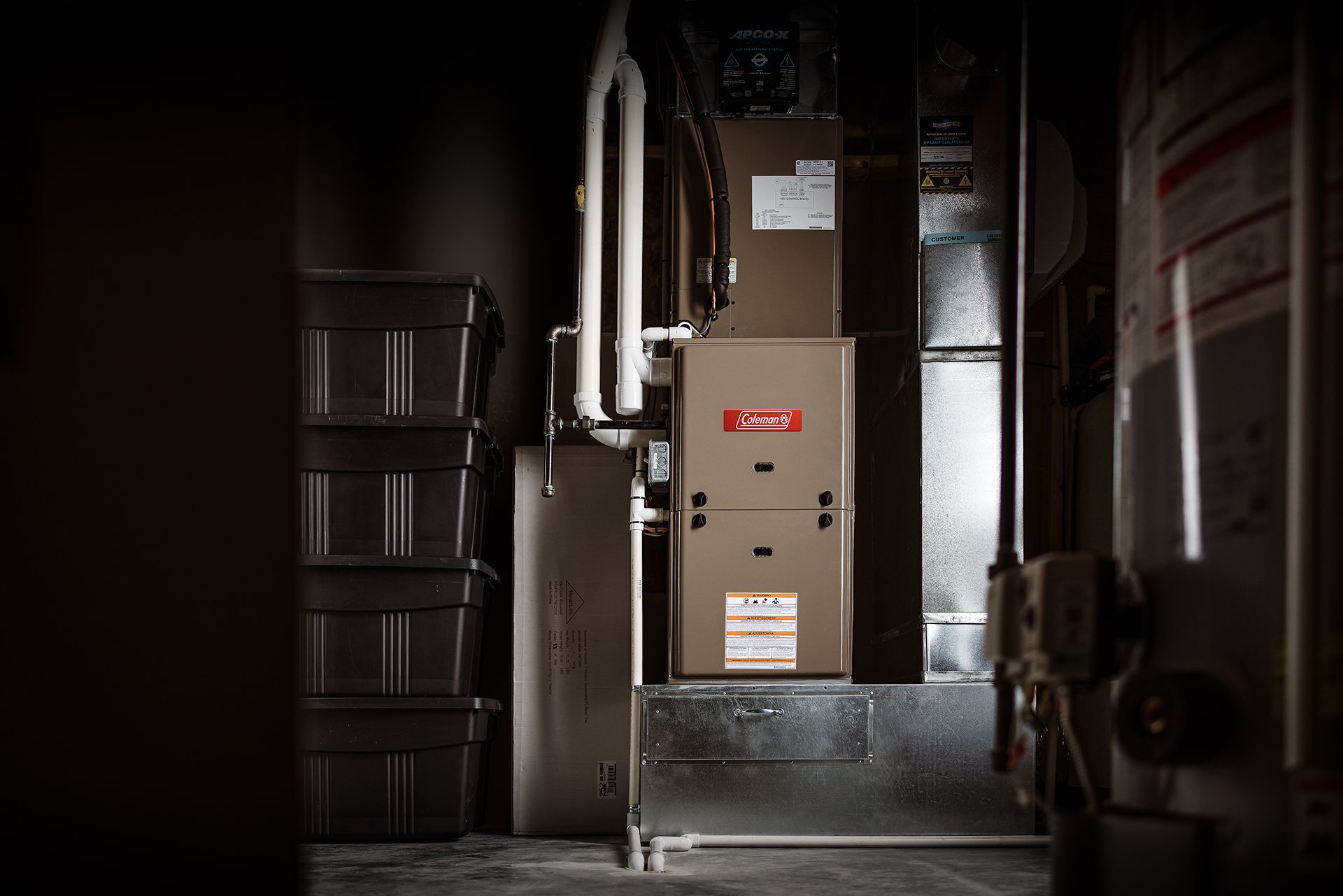 A furnace in a dark room with a red label on it