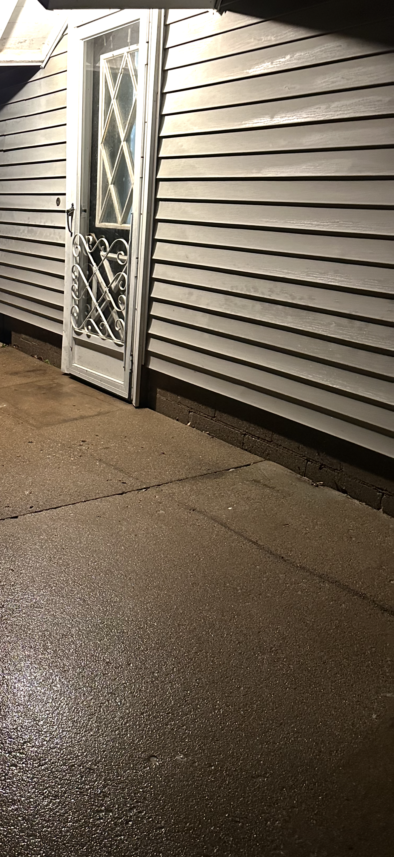There is a door on the side of a house.