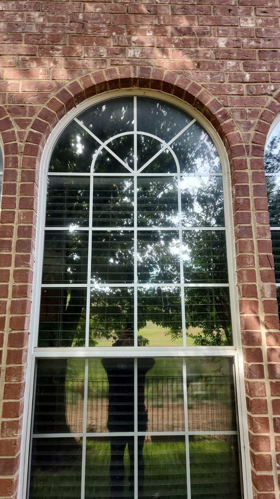 Large arched window on a brick building
