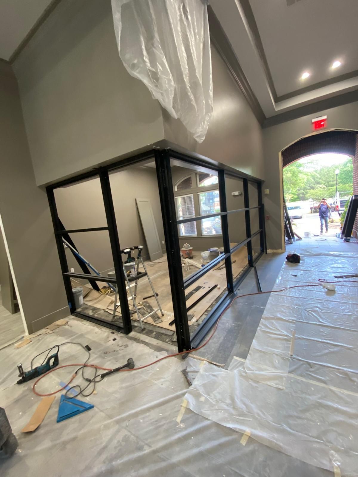 A room with a lot of windows is being remodeled.