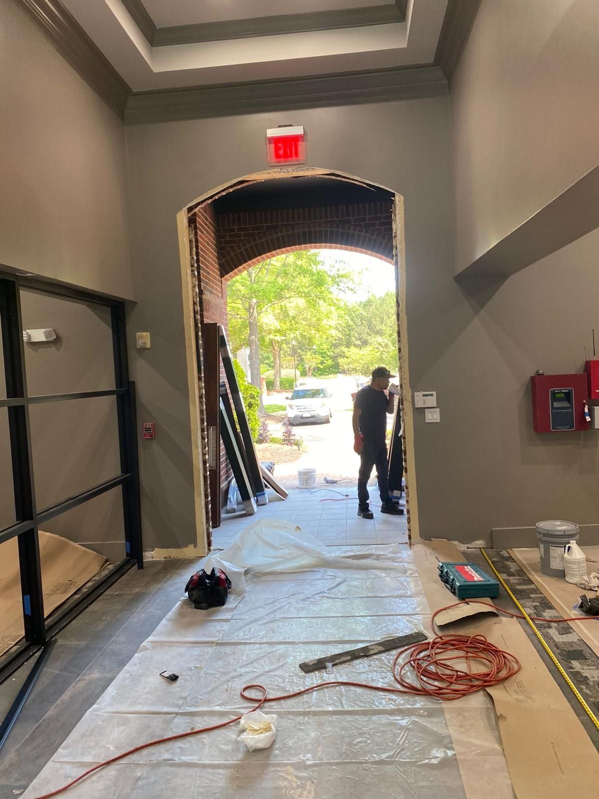 A man is standing in the doorway of a building.