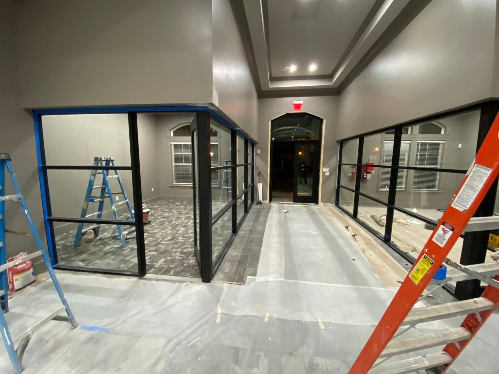 A hallway with a ladder in the middle of it.