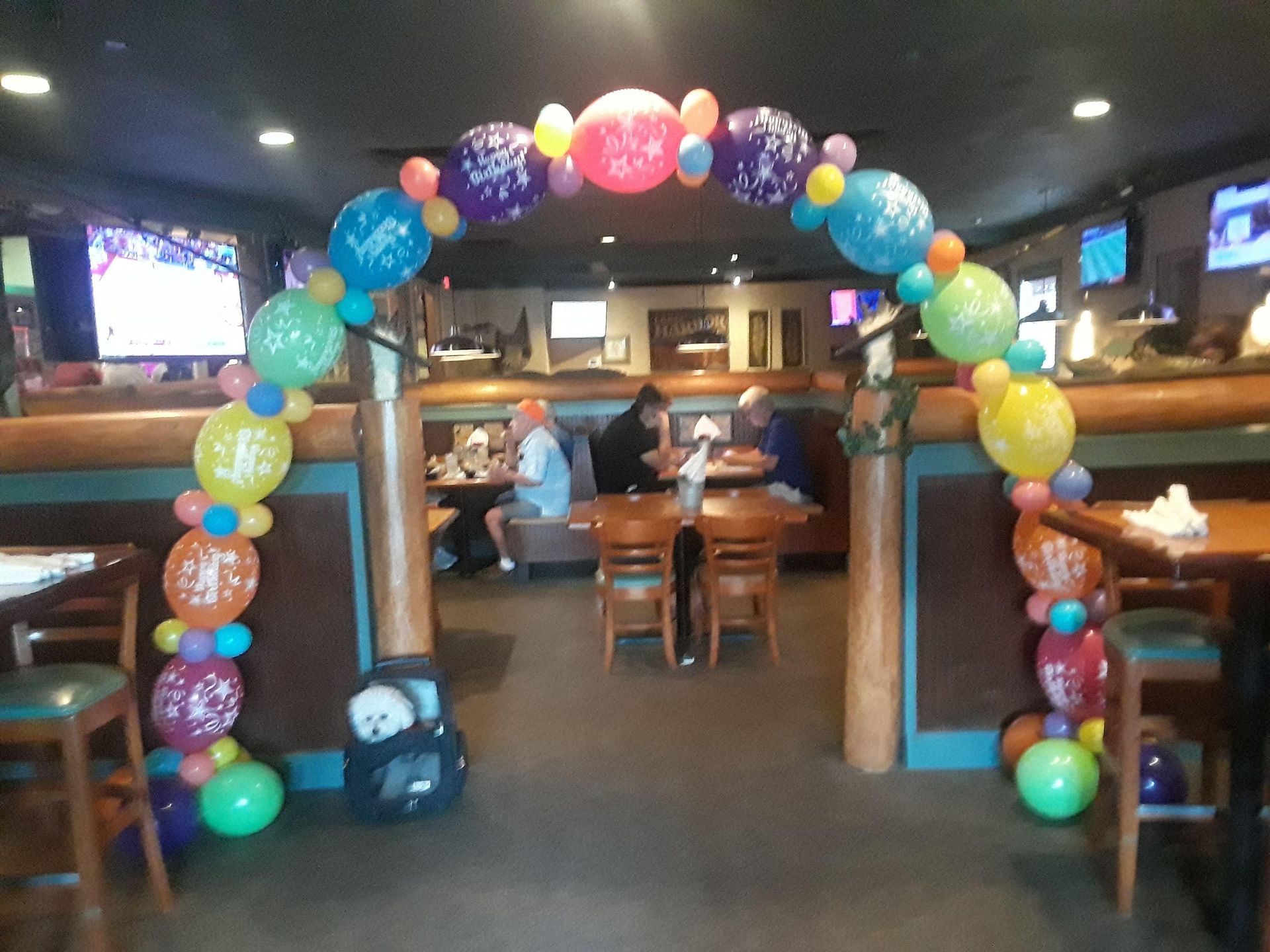 A restaurant is decorated with balloons for a birthday party