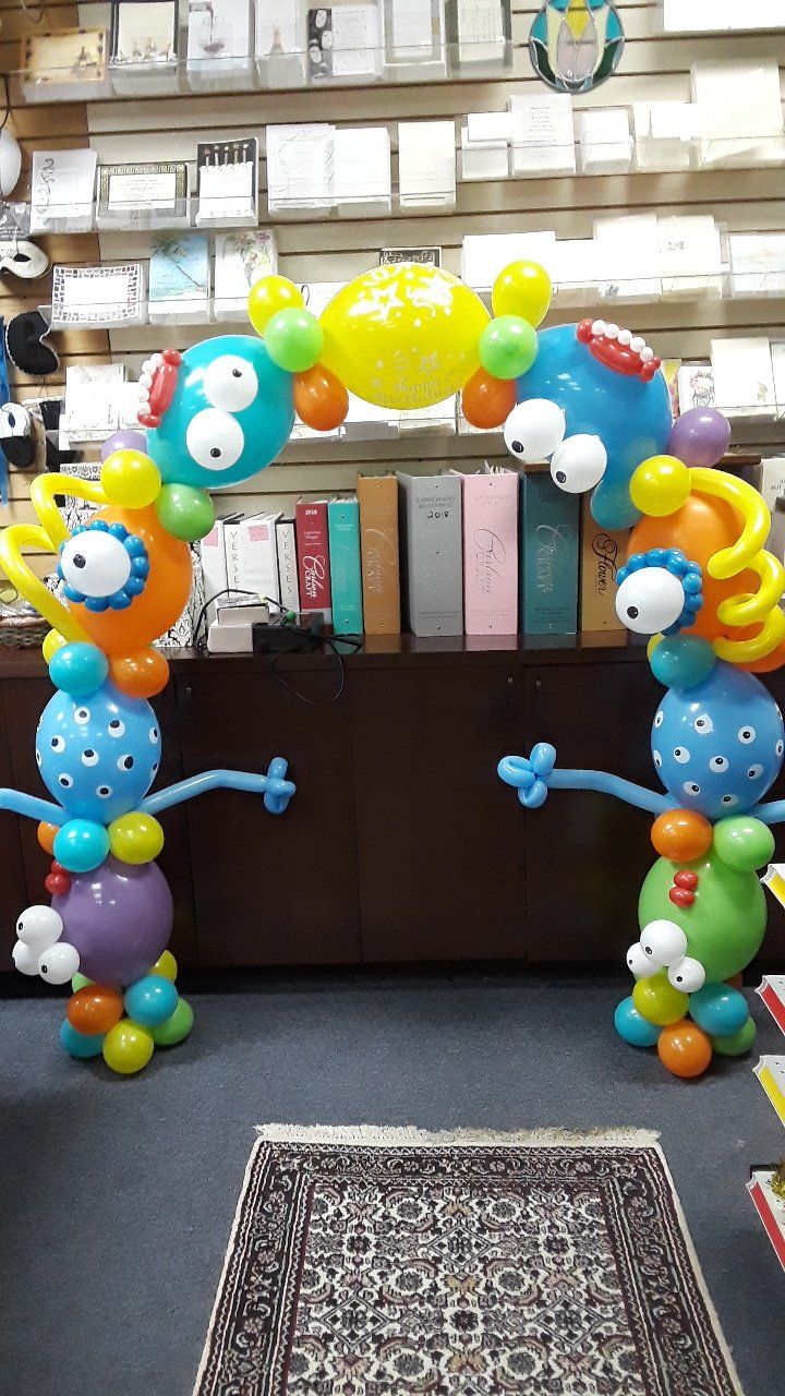 A bunch of balloons shaped like monsters in a store