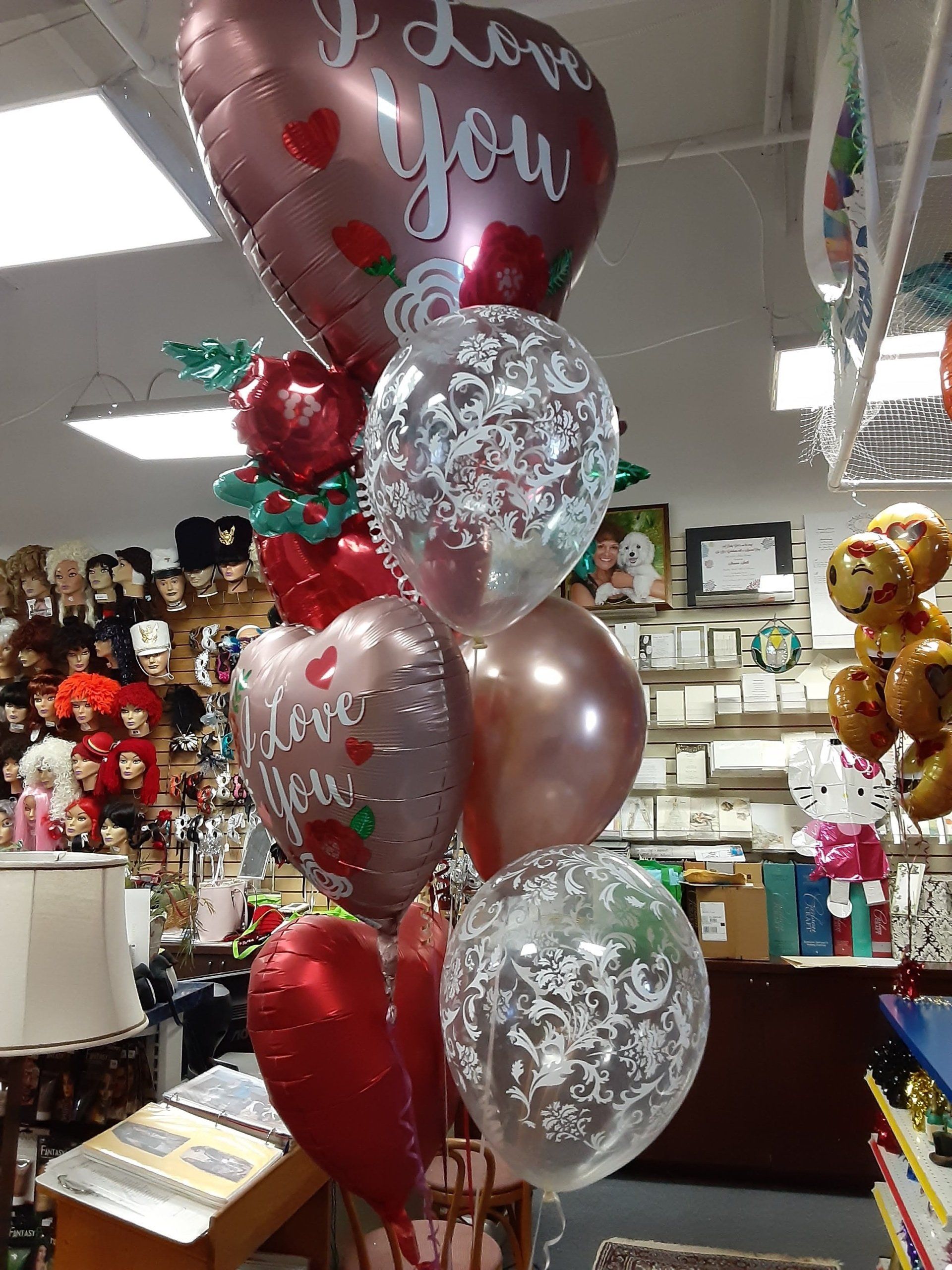 A bunch of balloons are stacked on top of each other in a store.