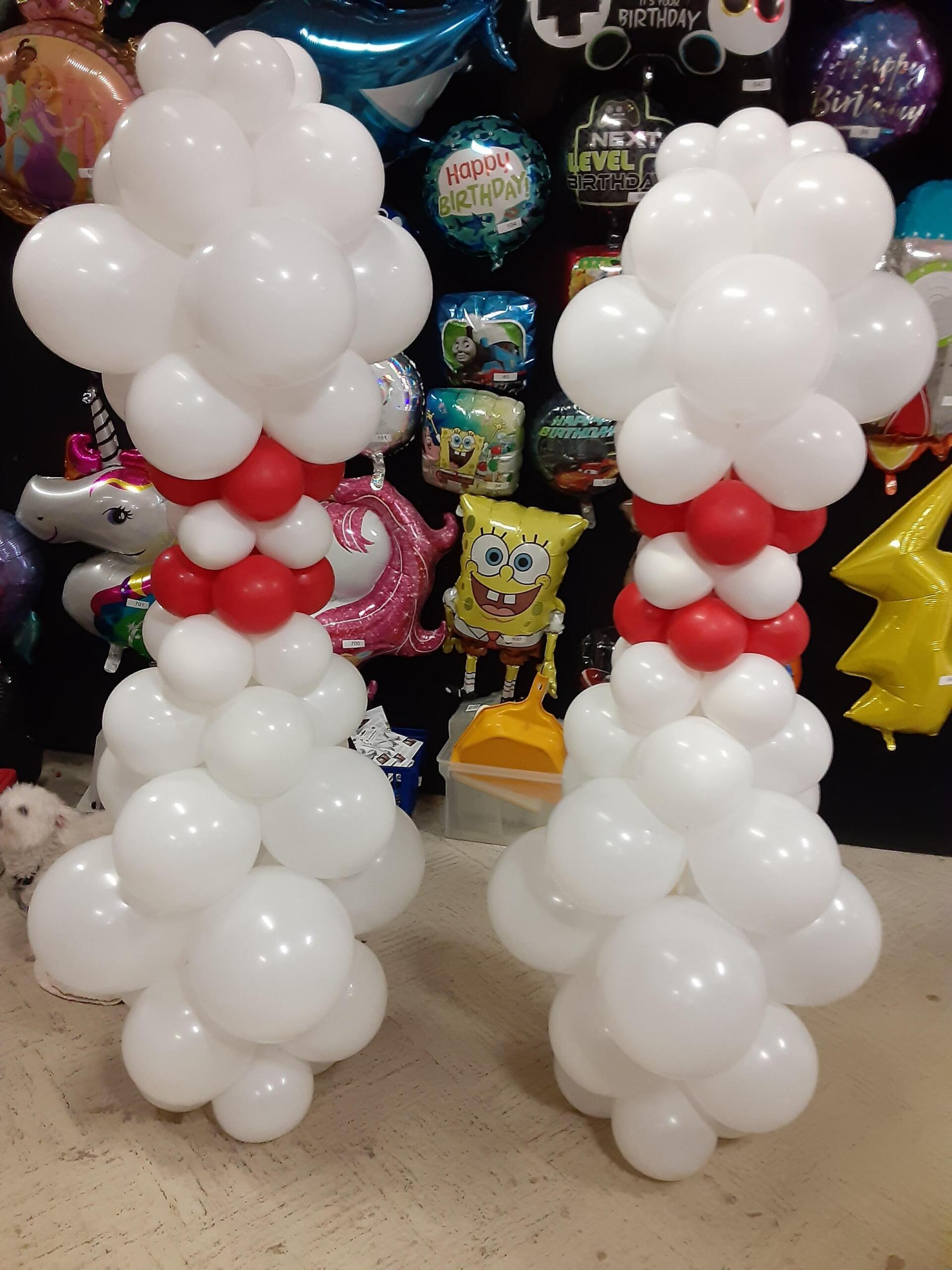 Two snowmen made out of white balloons with red bows