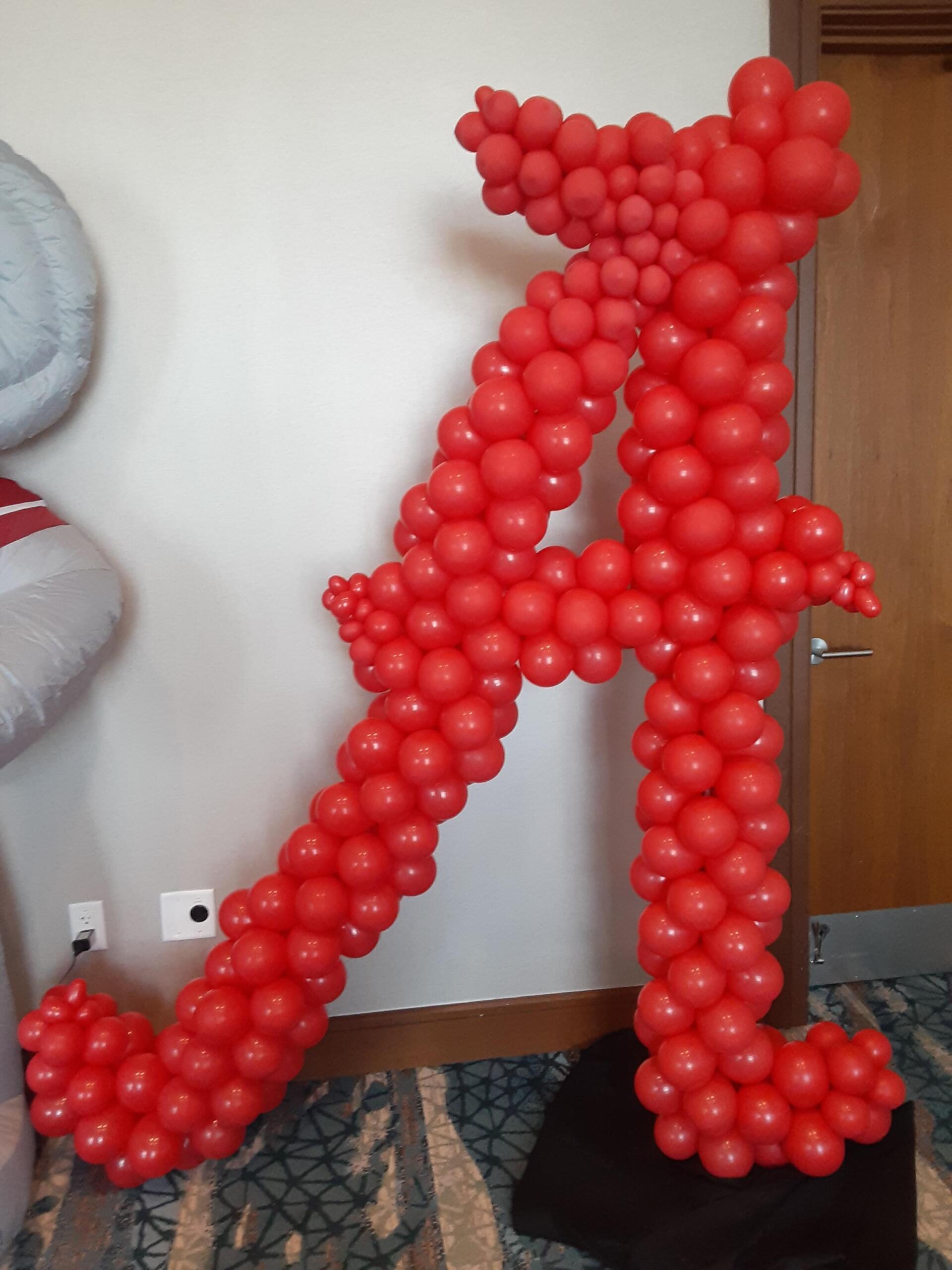 A large letter a made out of red balloons