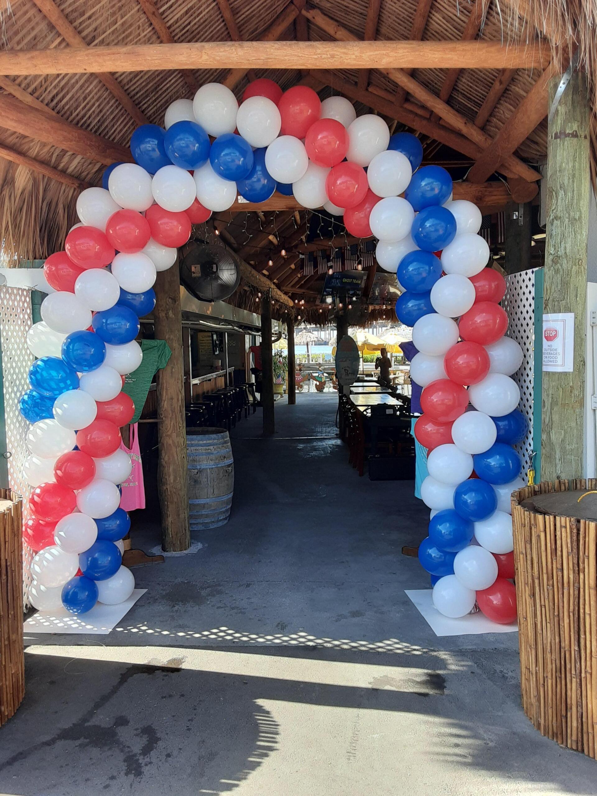 An arch made of red white and blue balloons