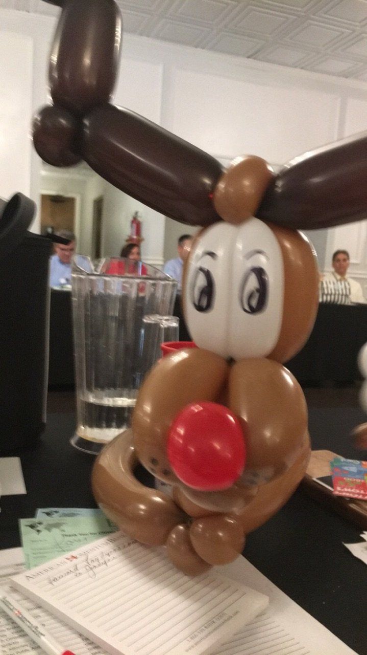 A reindeer made out of balloons with a red nose