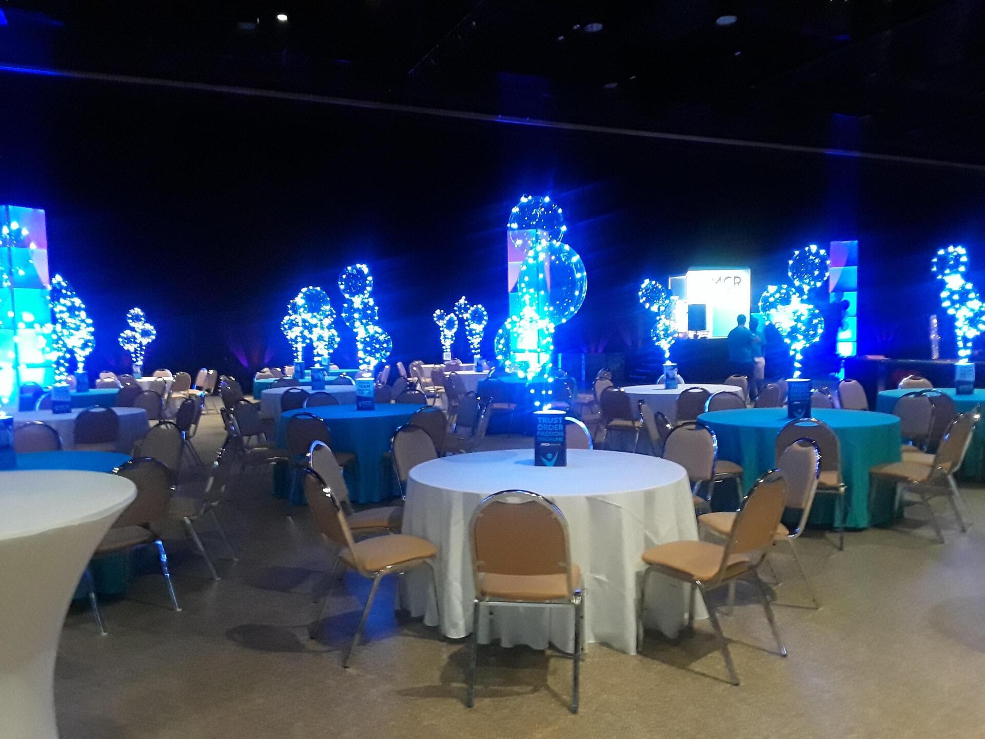 A large room with tables and chairs set up for a party