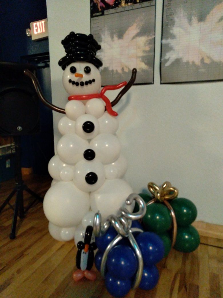 A snowman made out of balloons with a red scarf around his neck