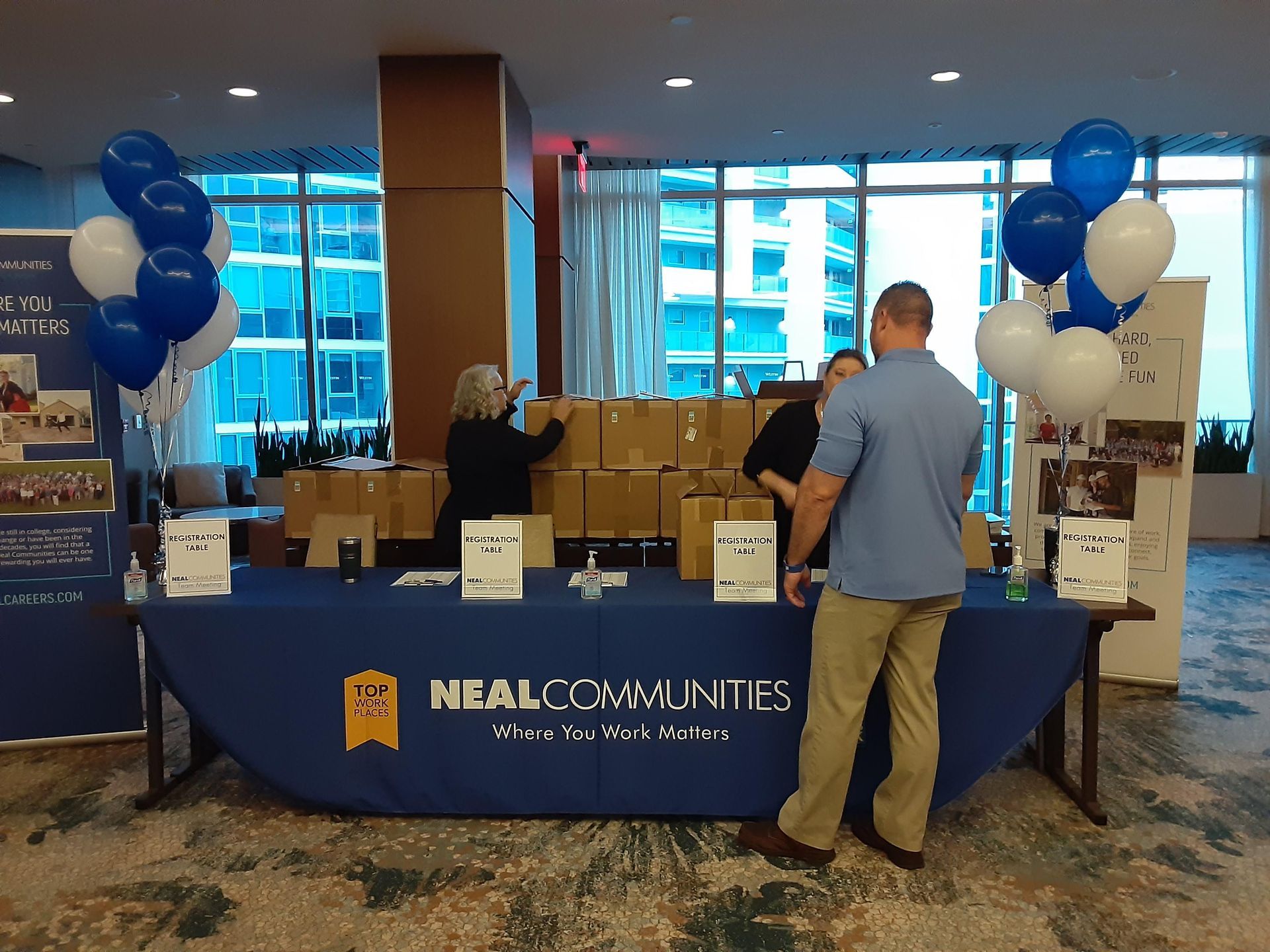 People standing around a table that says nial communities