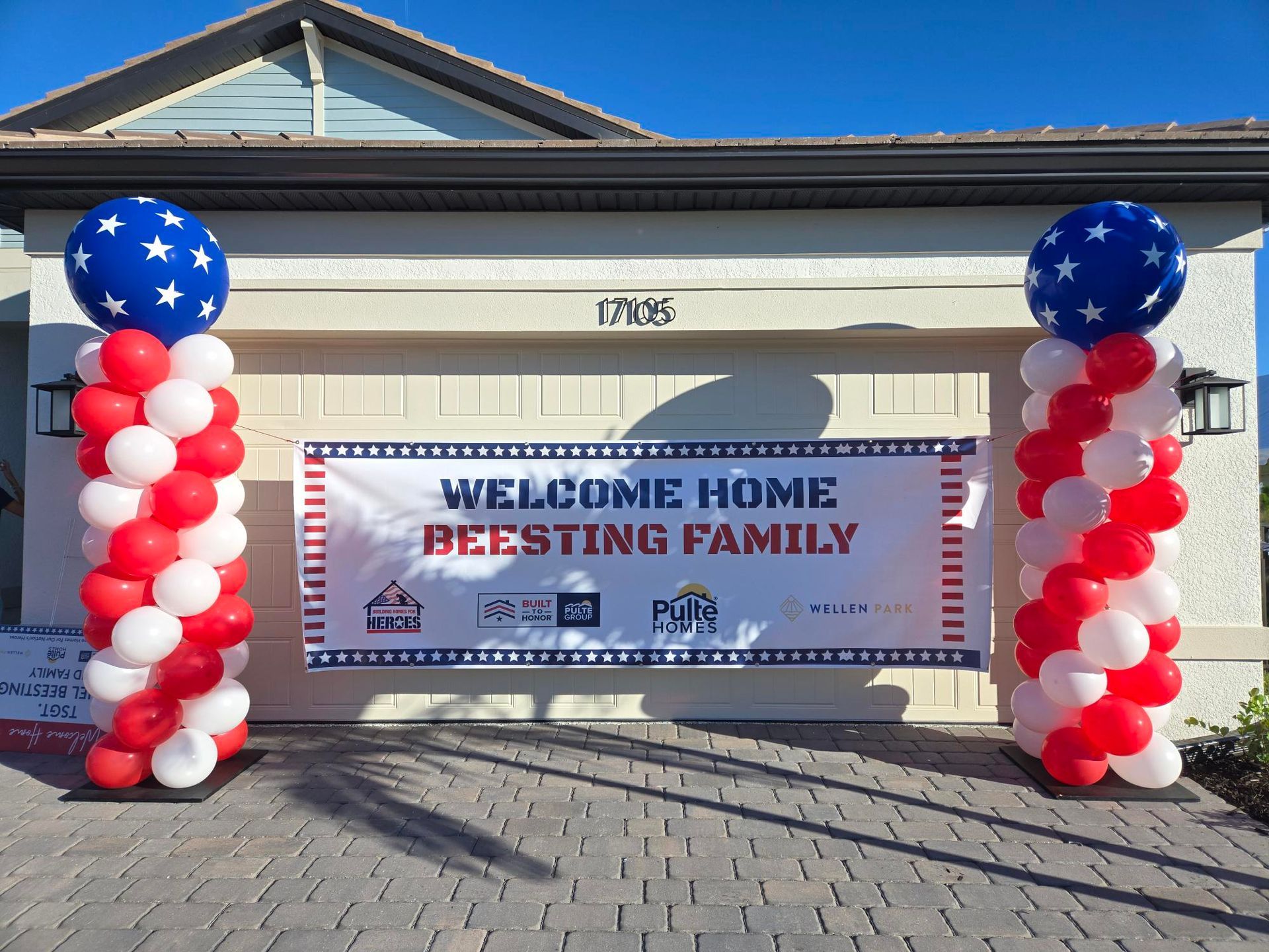 Garage entrance decorated with red, white, and blue balloons