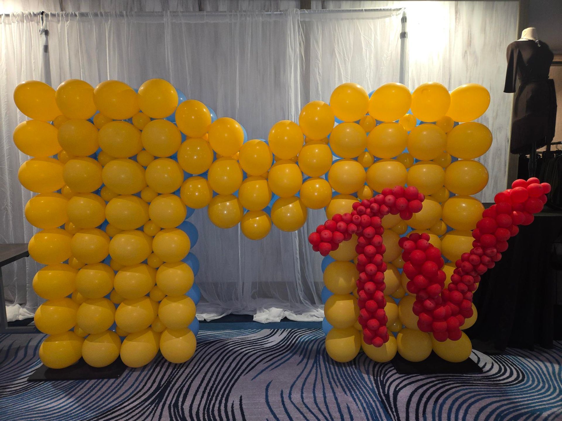 Yellow balloon arch with red balloons