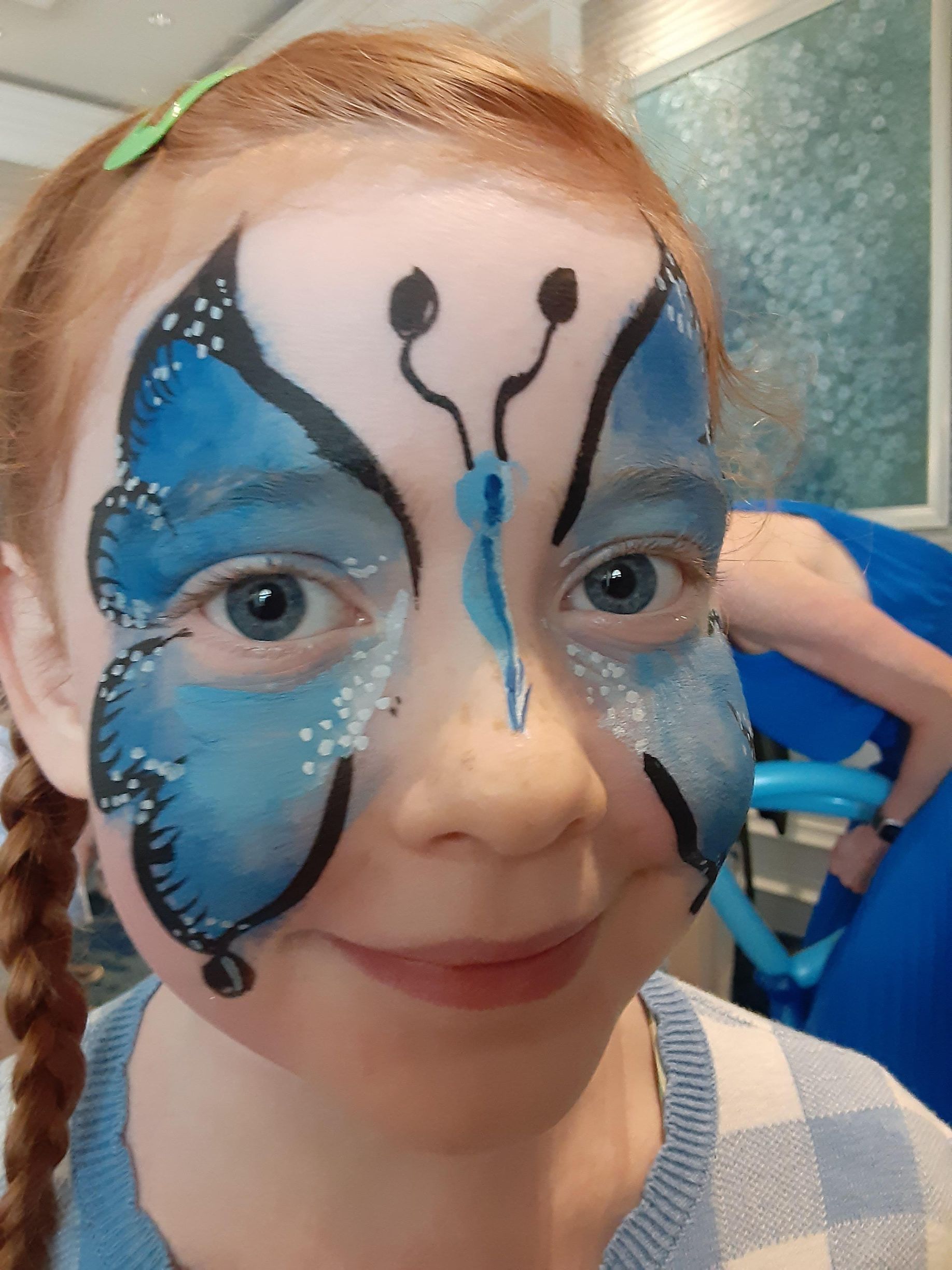 Girl with blue butterfly face paint