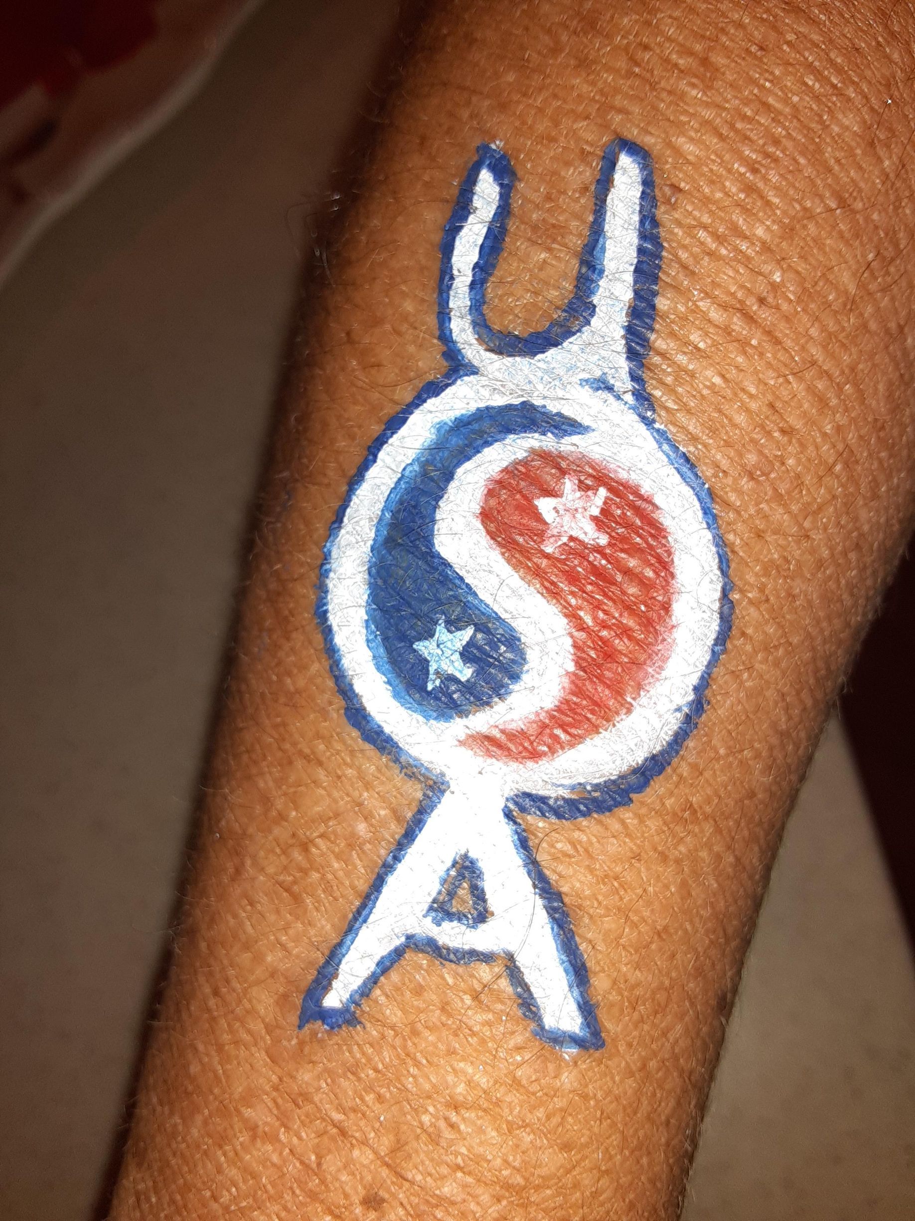 Body art, blue, white, and red design on arm