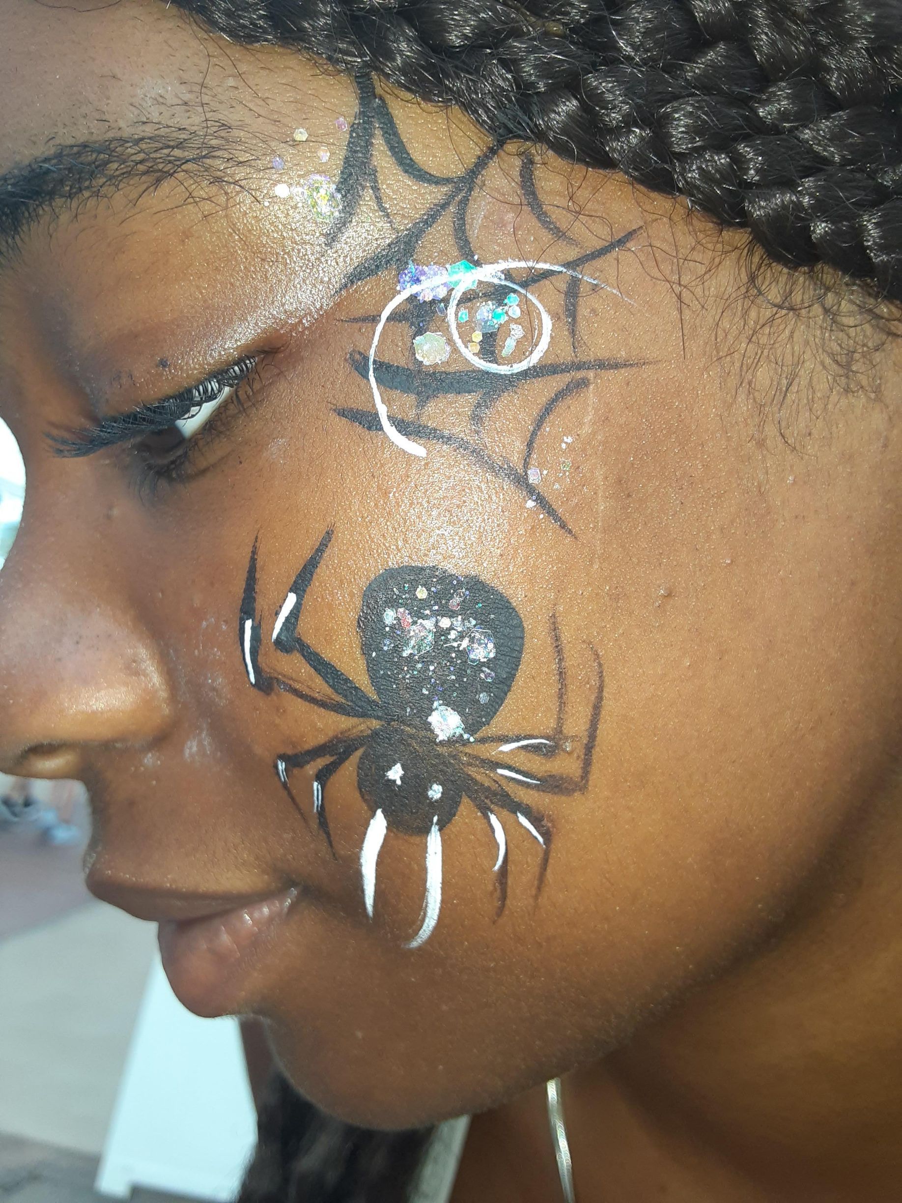 Woman's face with spiderweb and spider face paint