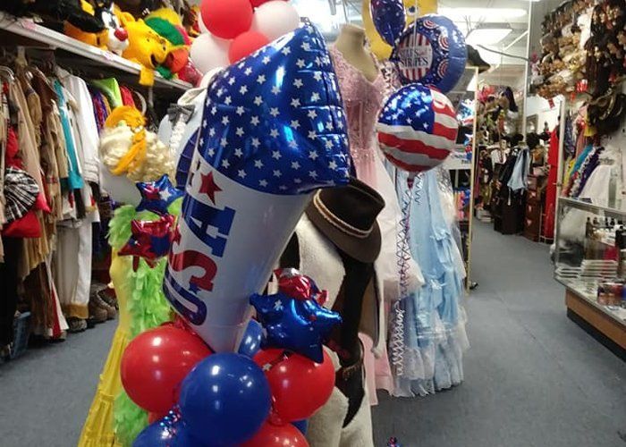 A store filled with lots of balloons including one that says usa