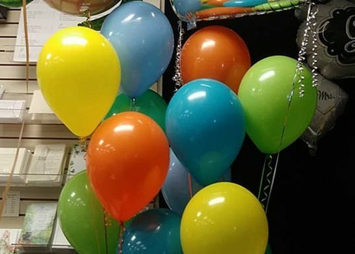 A bunch of colorful balloons are sitting on a table