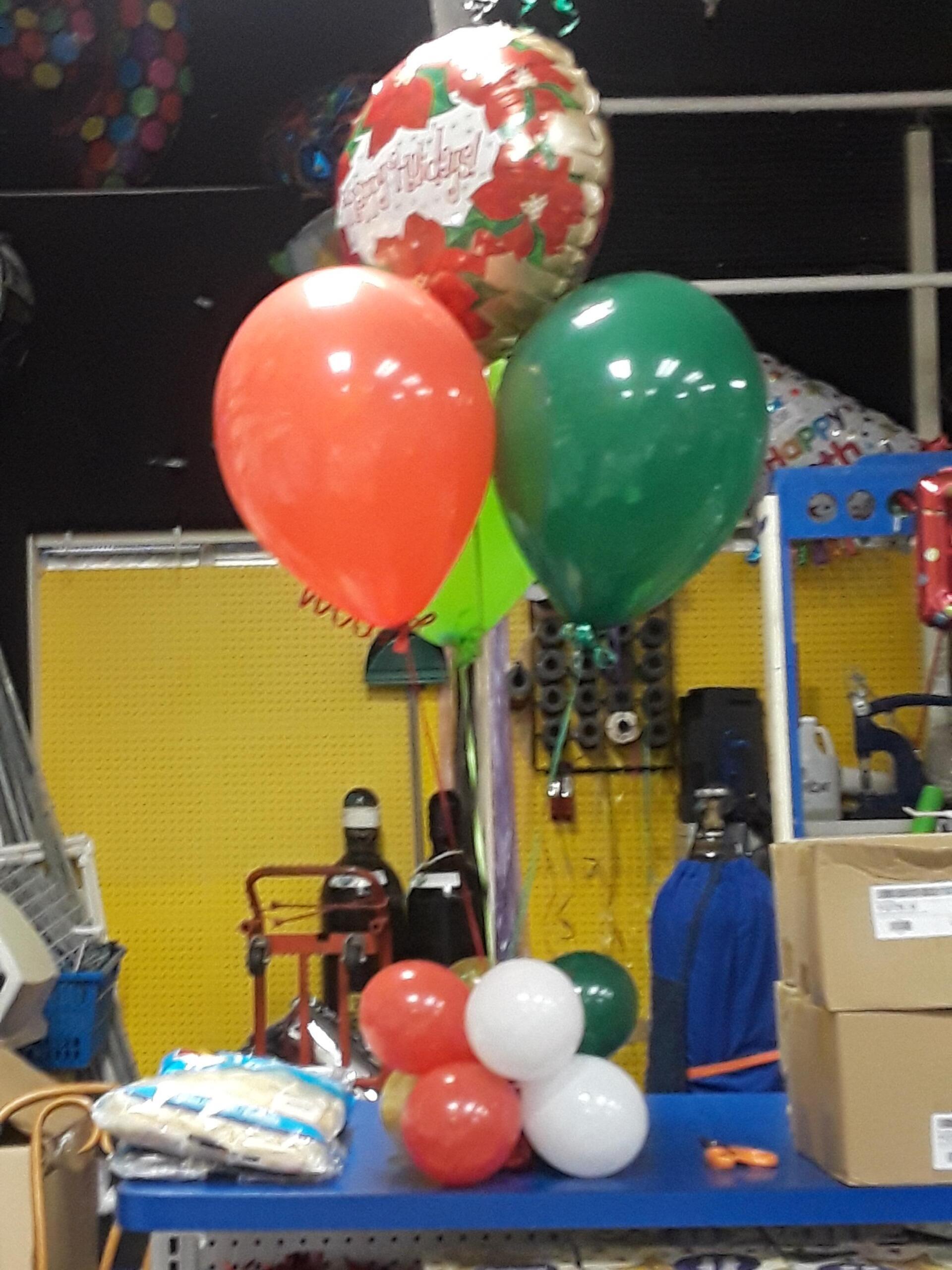 A bunch of balloons with one that says congratulations on it