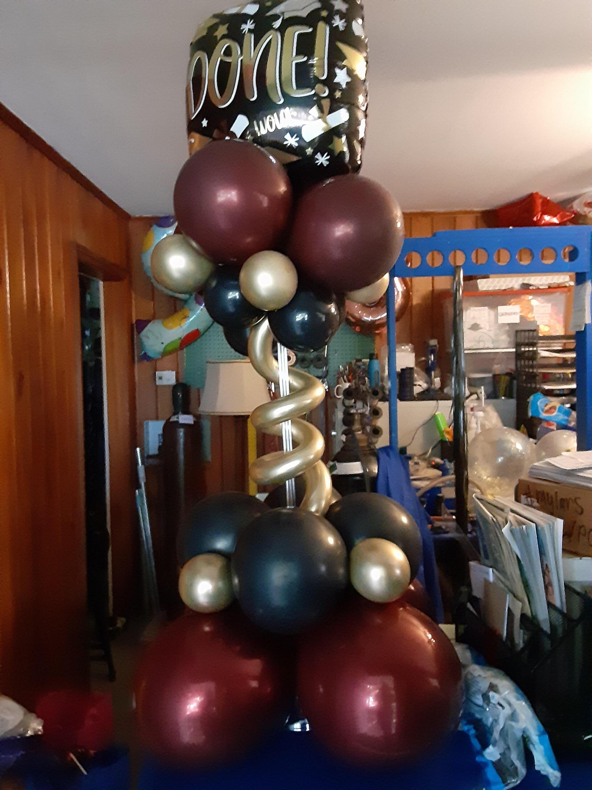 A bunch of balloons with one that says done on it