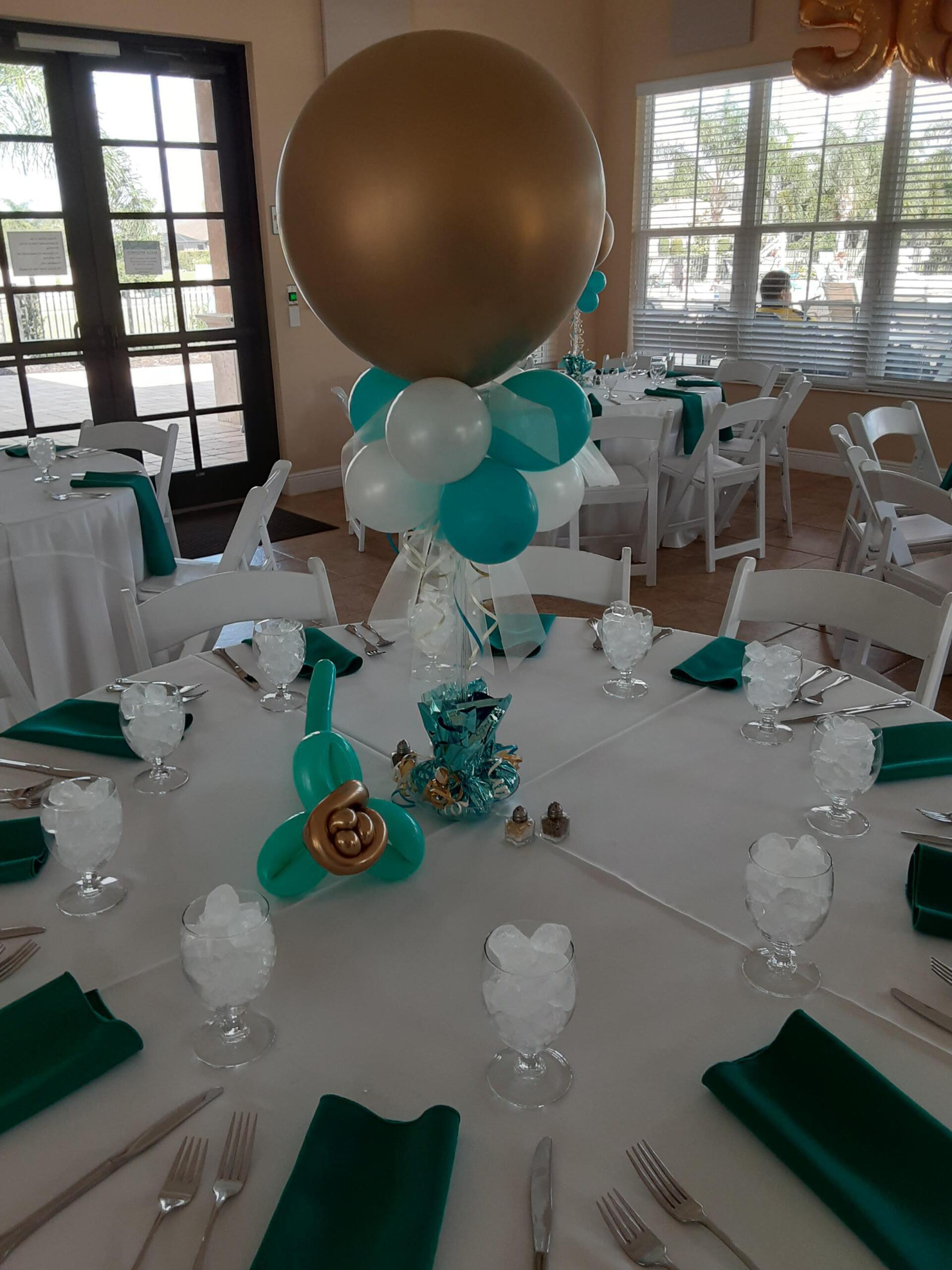 A table set for a party with balloons on it.