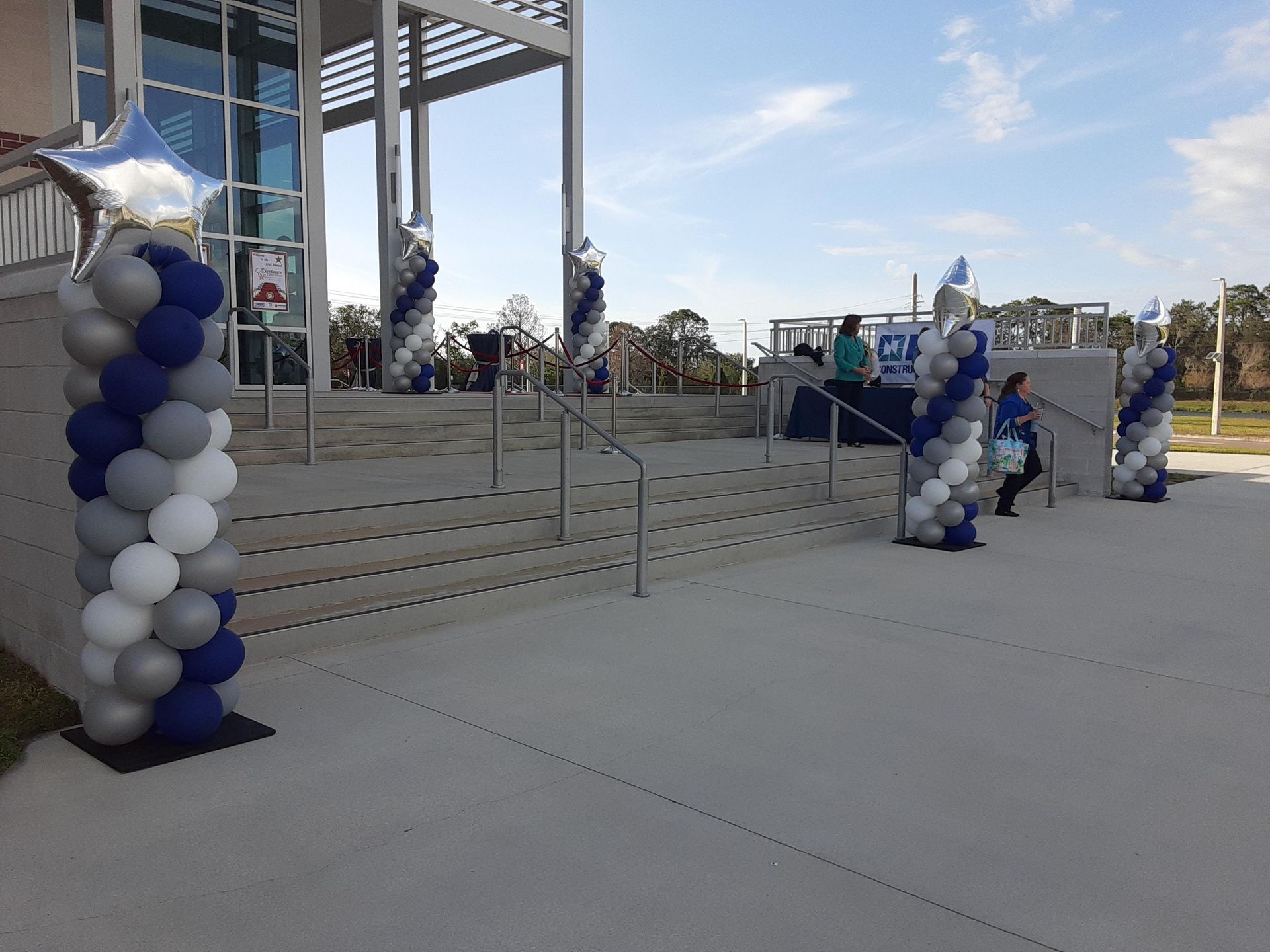 A row of balloons are lined up in front of a building