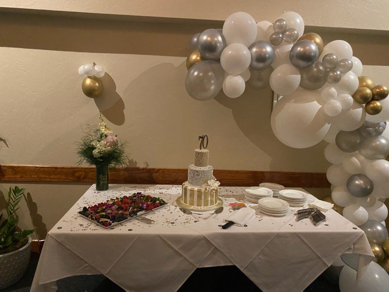 A table with a cake and balloons on it