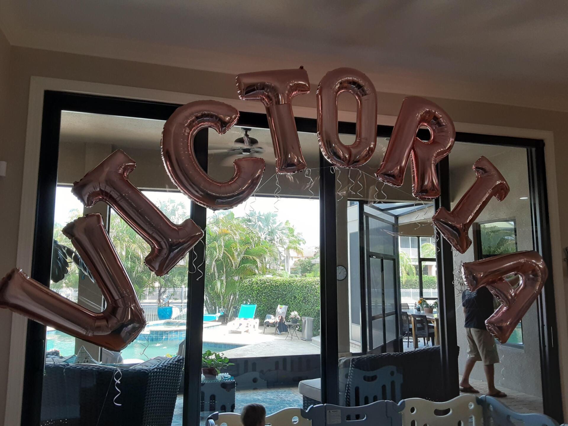 A bunch of balloons with the word victoria on them