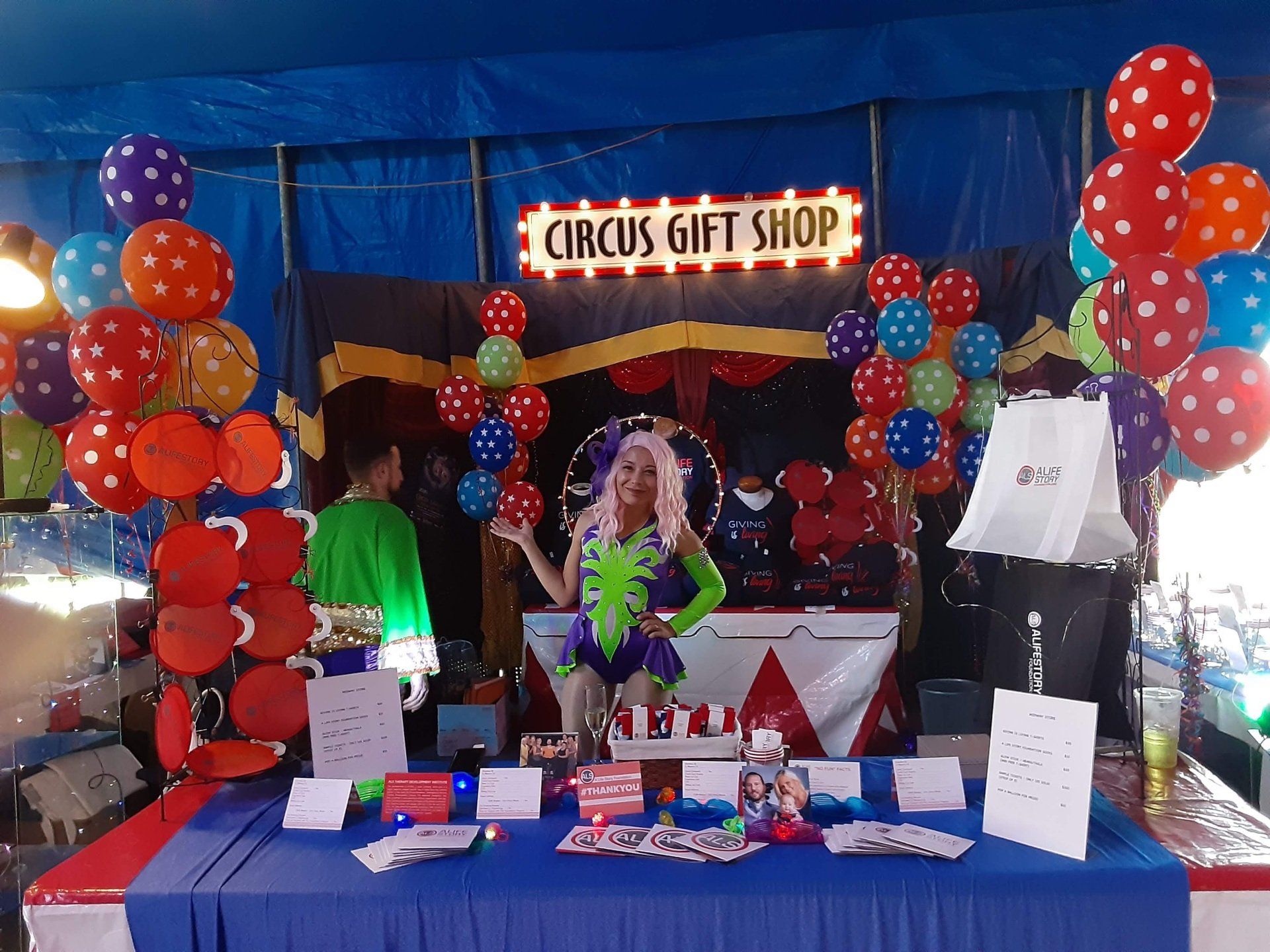 A woman stands in front of a circus gift shop