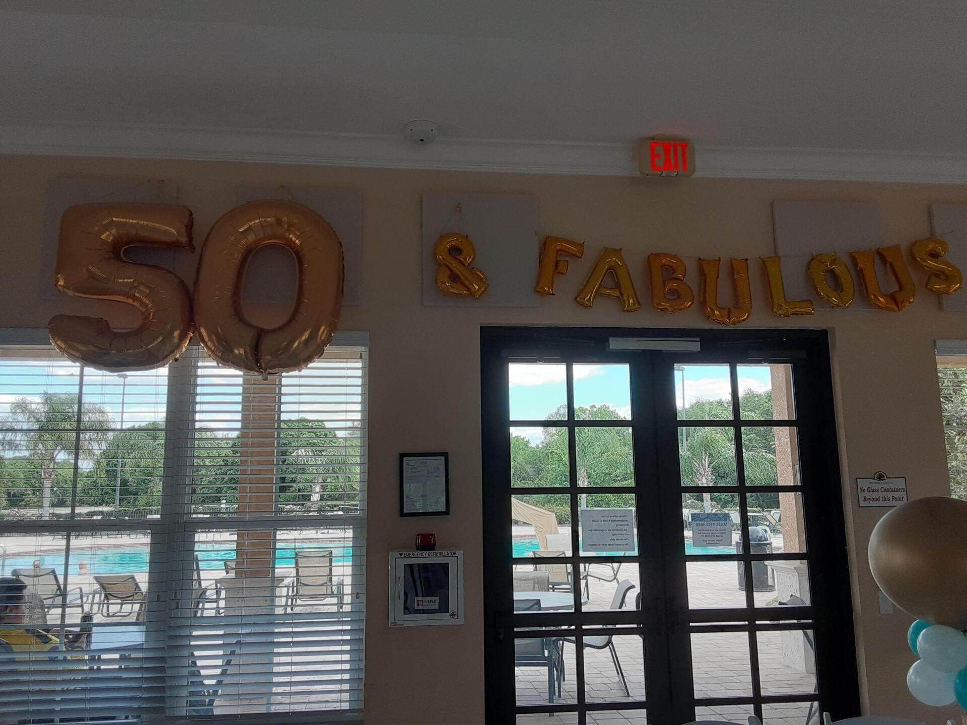 A room with balloons that say 50 and fabulous