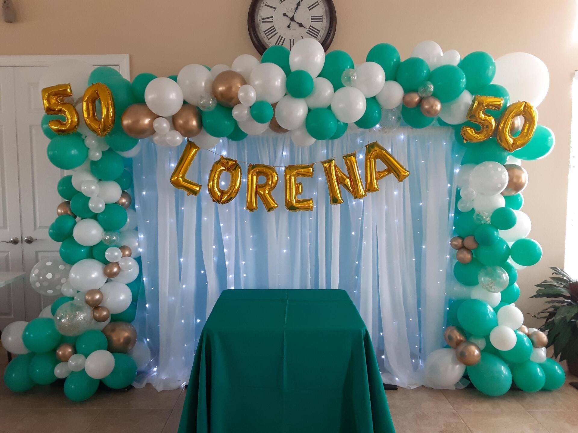 A room decorated with balloons and the name lorena