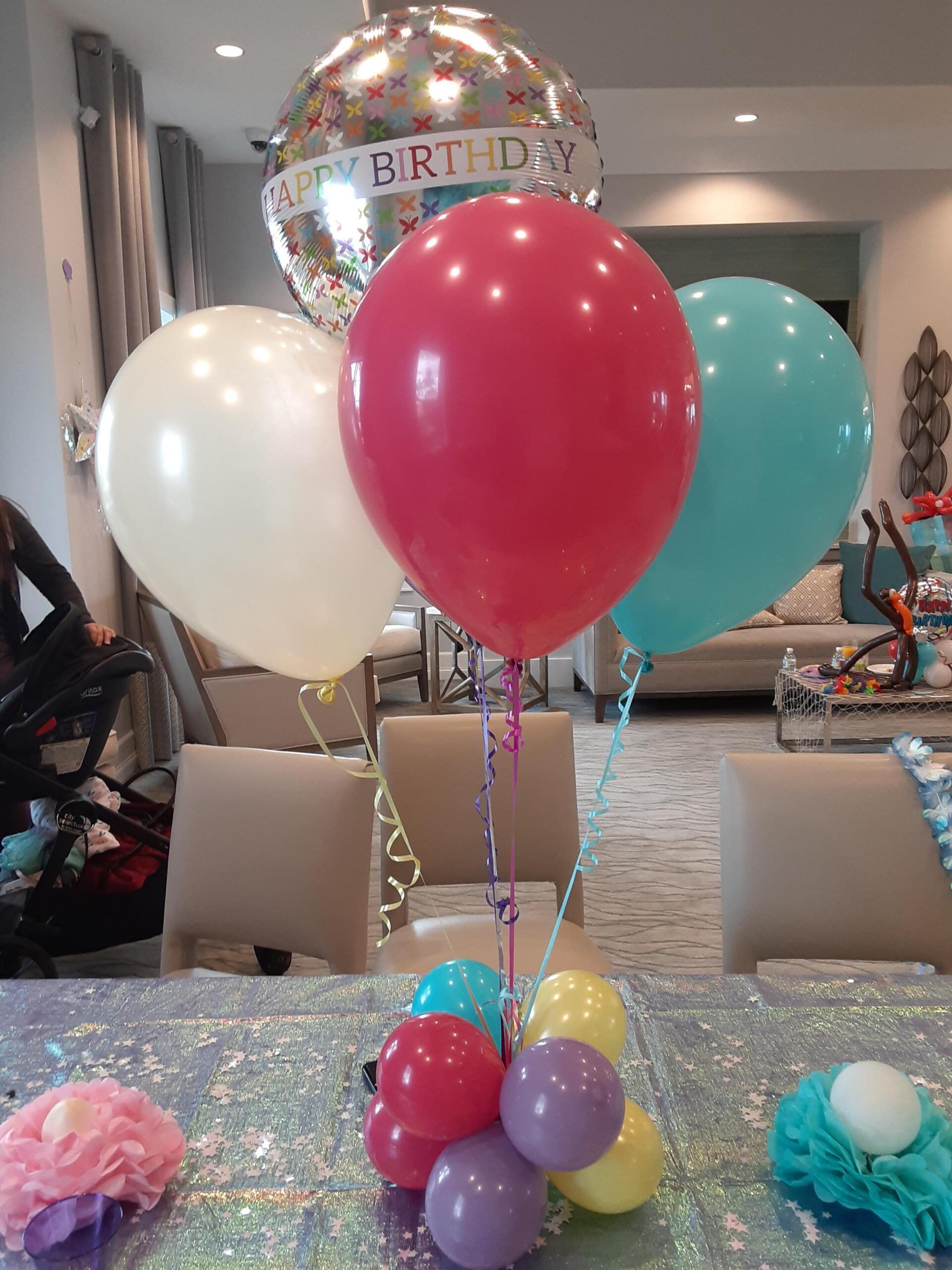A bunch of balloons are sitting on top of a table.