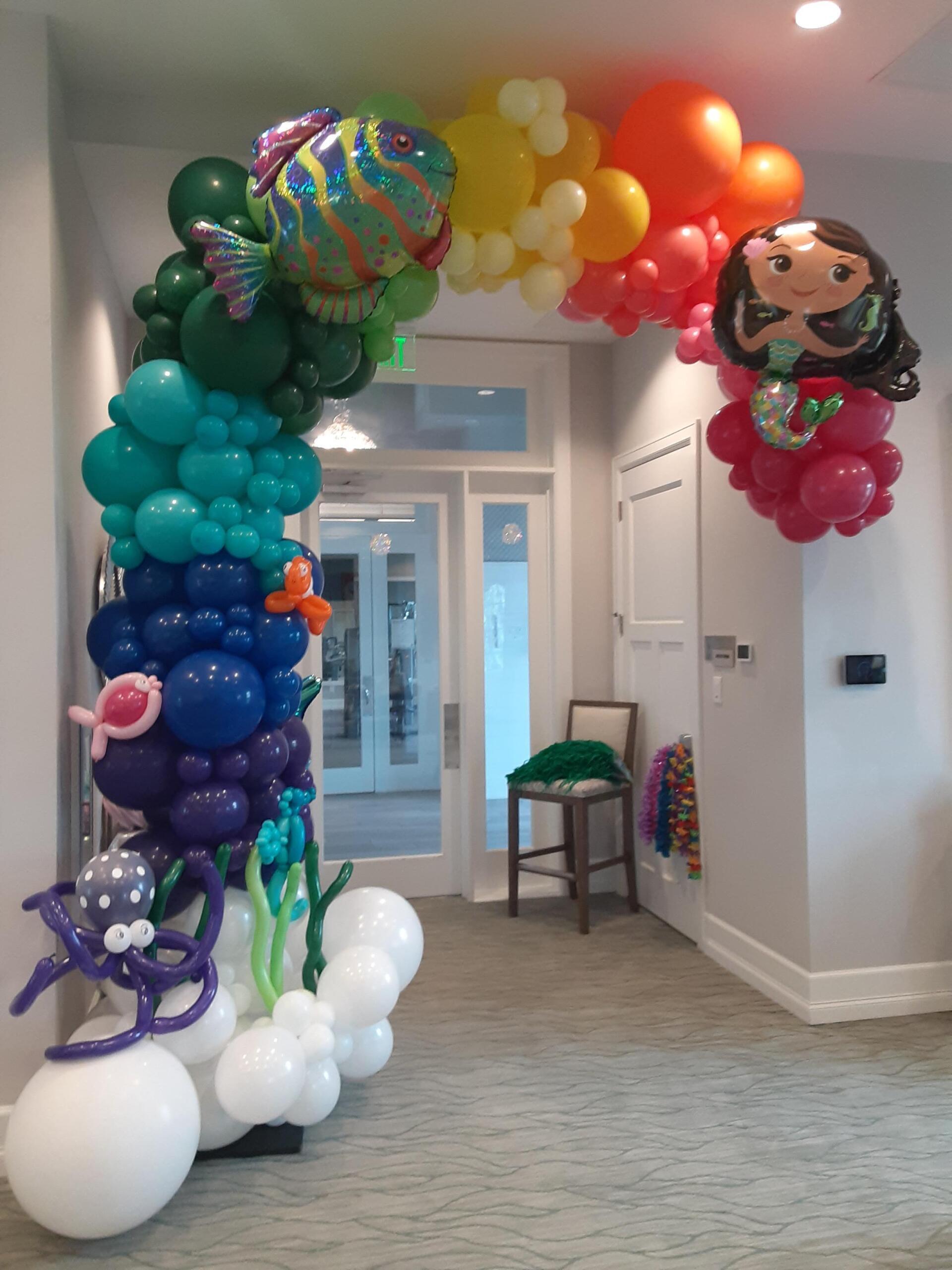 A hallway filled with balloons and a chair