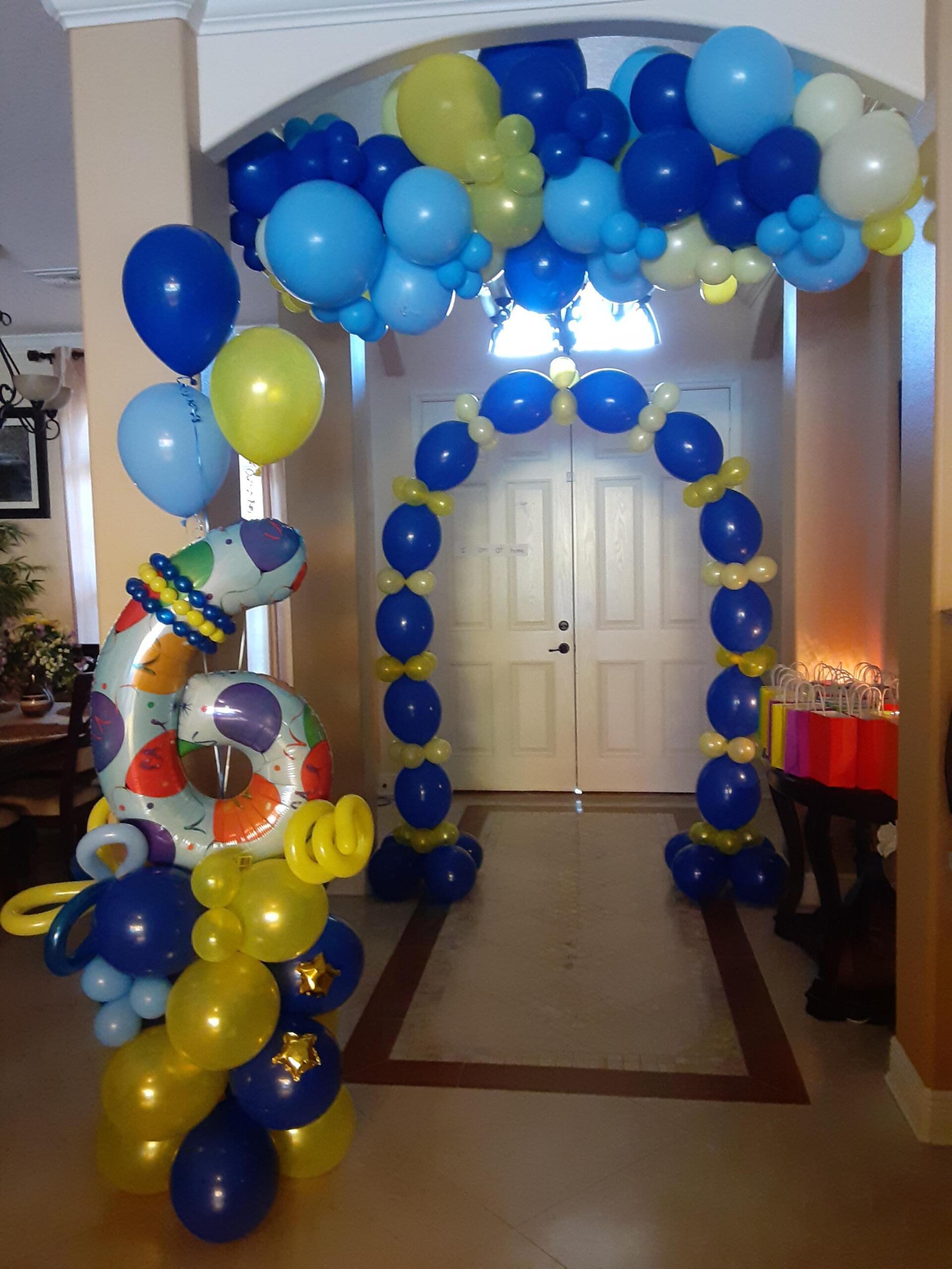 A hallway decorated with blue and yellow balloons