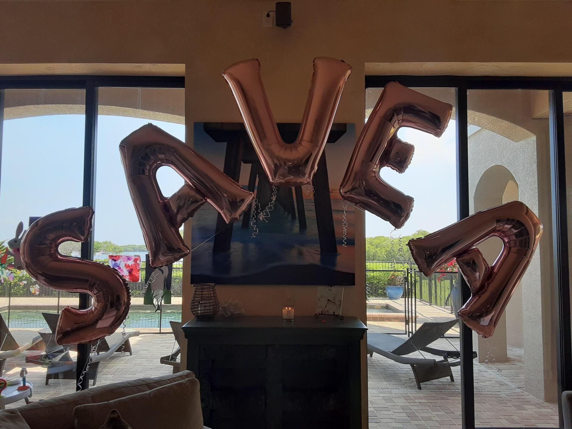 A living room with balloons in the shape of the word save