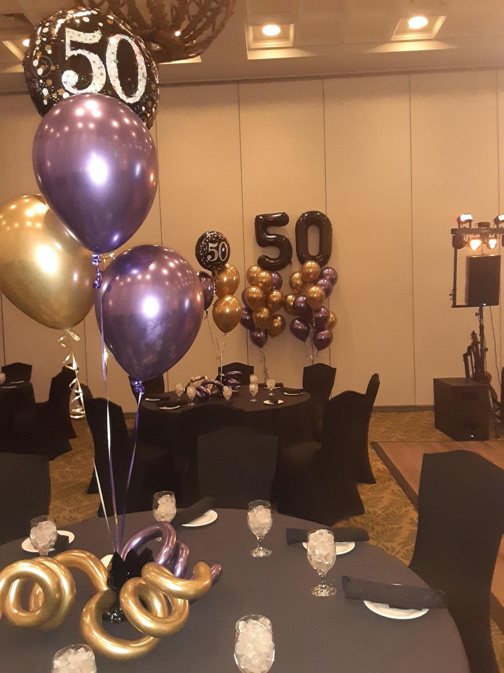 Purple and gold balloons with the number 50 on them