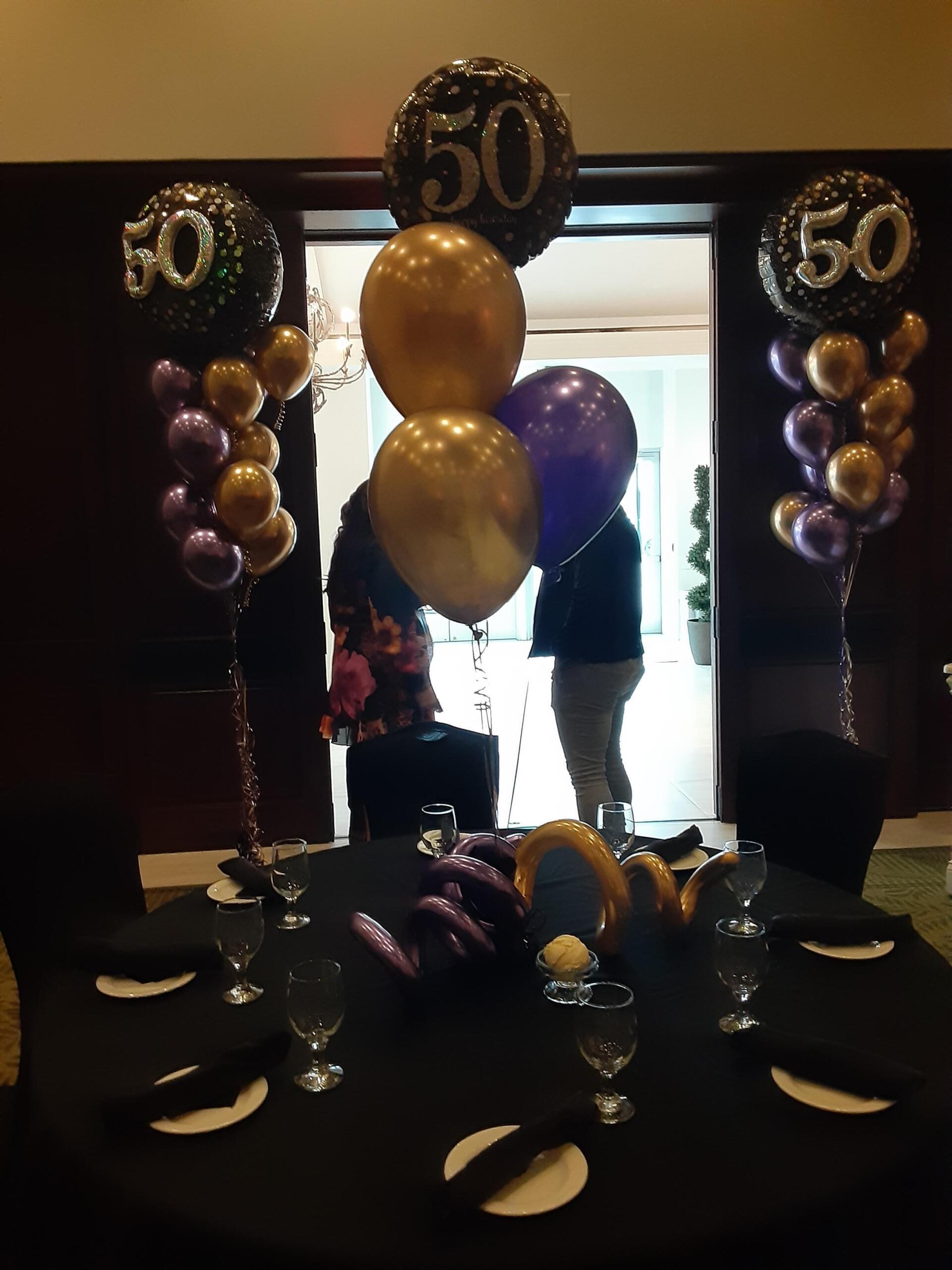 A bunch of balloons with the number 50 on them