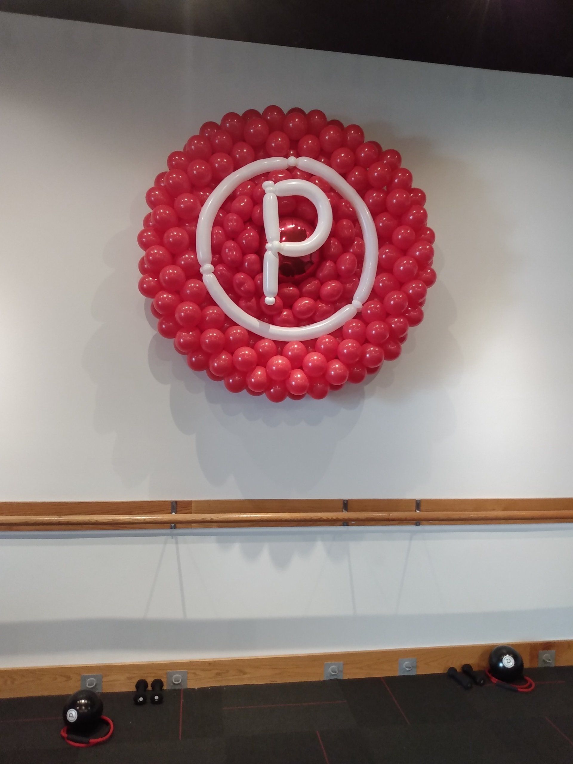 The letter p is made out of red balloons