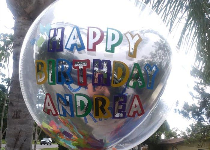 A clear balloon that says happy birthday andrea