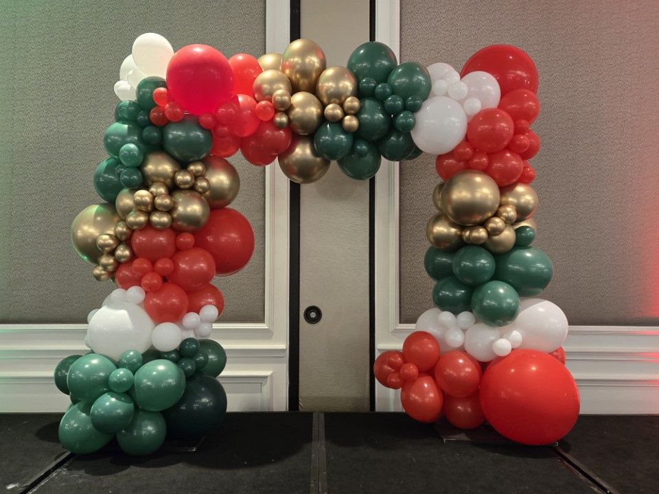 A bunch of balloons are sitting on a table in a room.