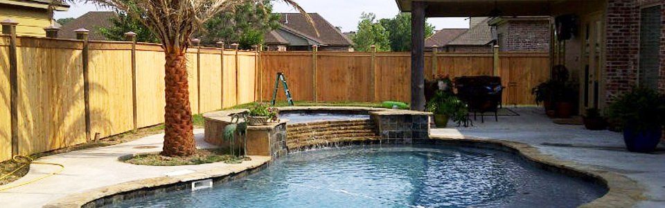 wood fence surrounding pool