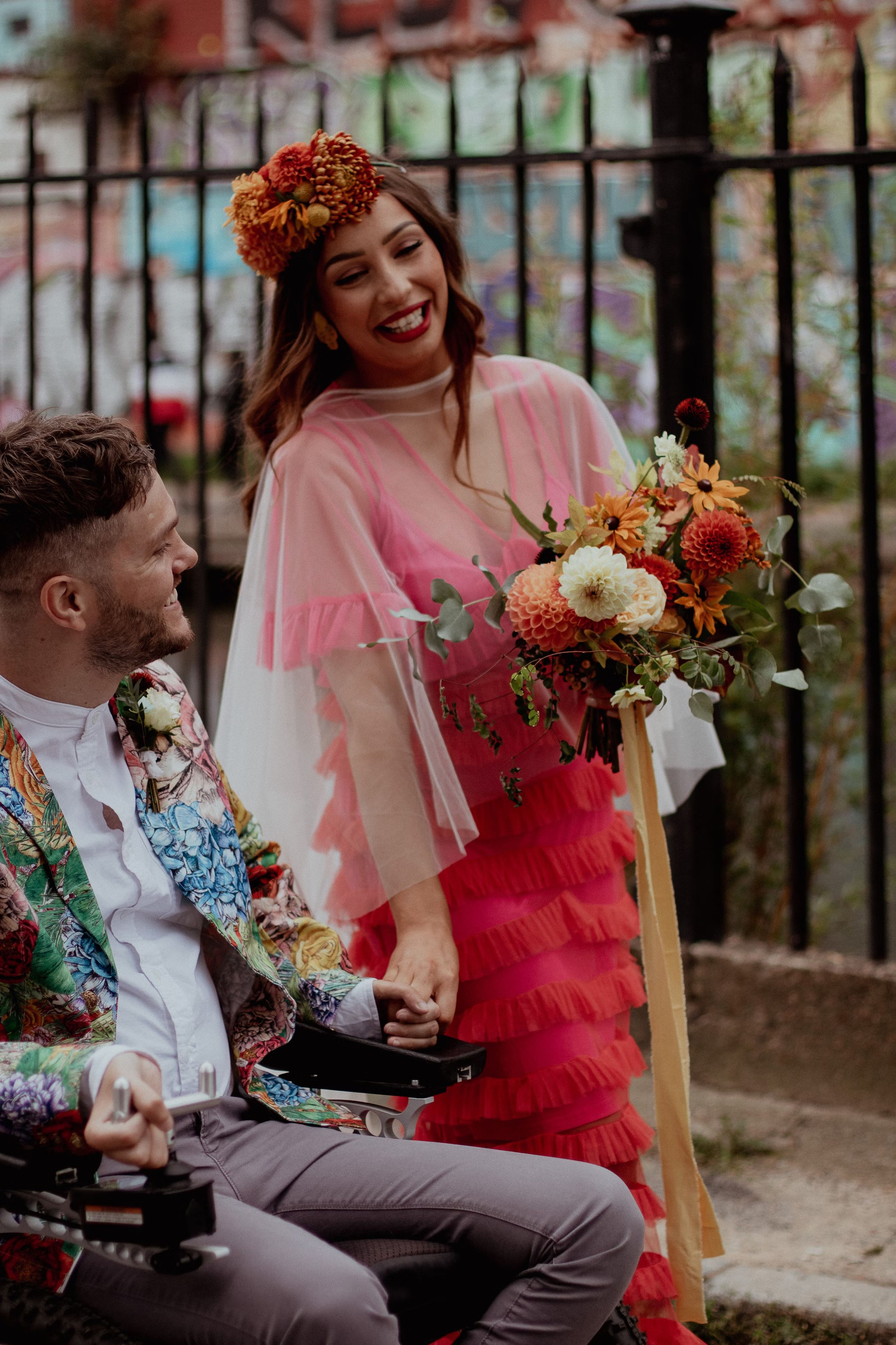 A man in a wheelchair and a woman on their wedding day.