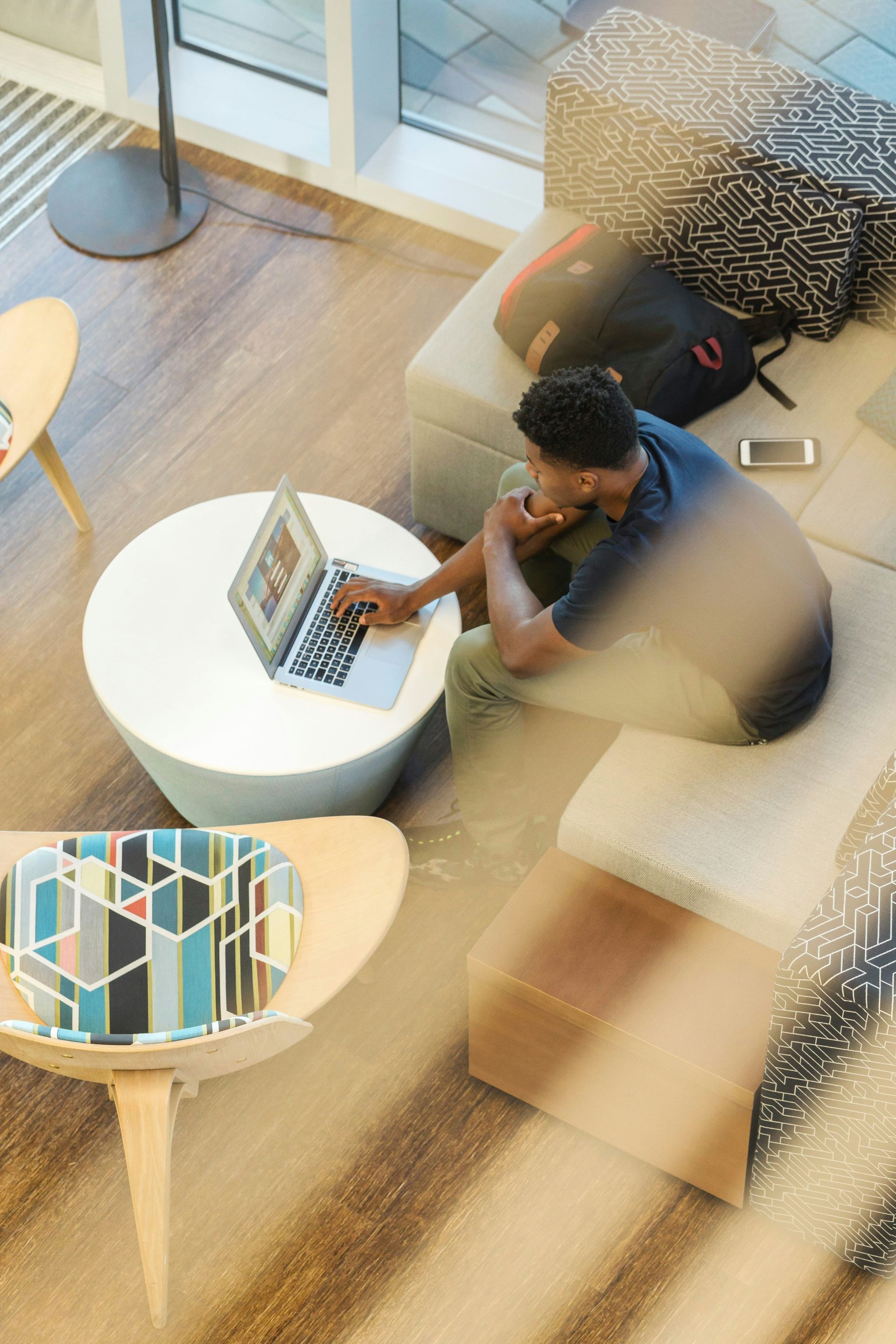 A man works on a laptop a table.