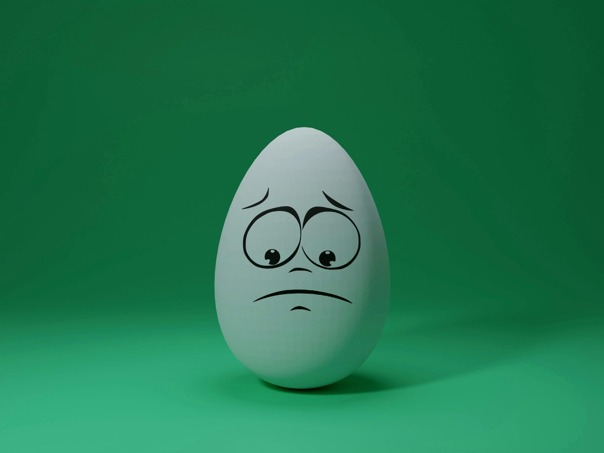 A sad, worried face is drawn onto an egg sitting alone. 