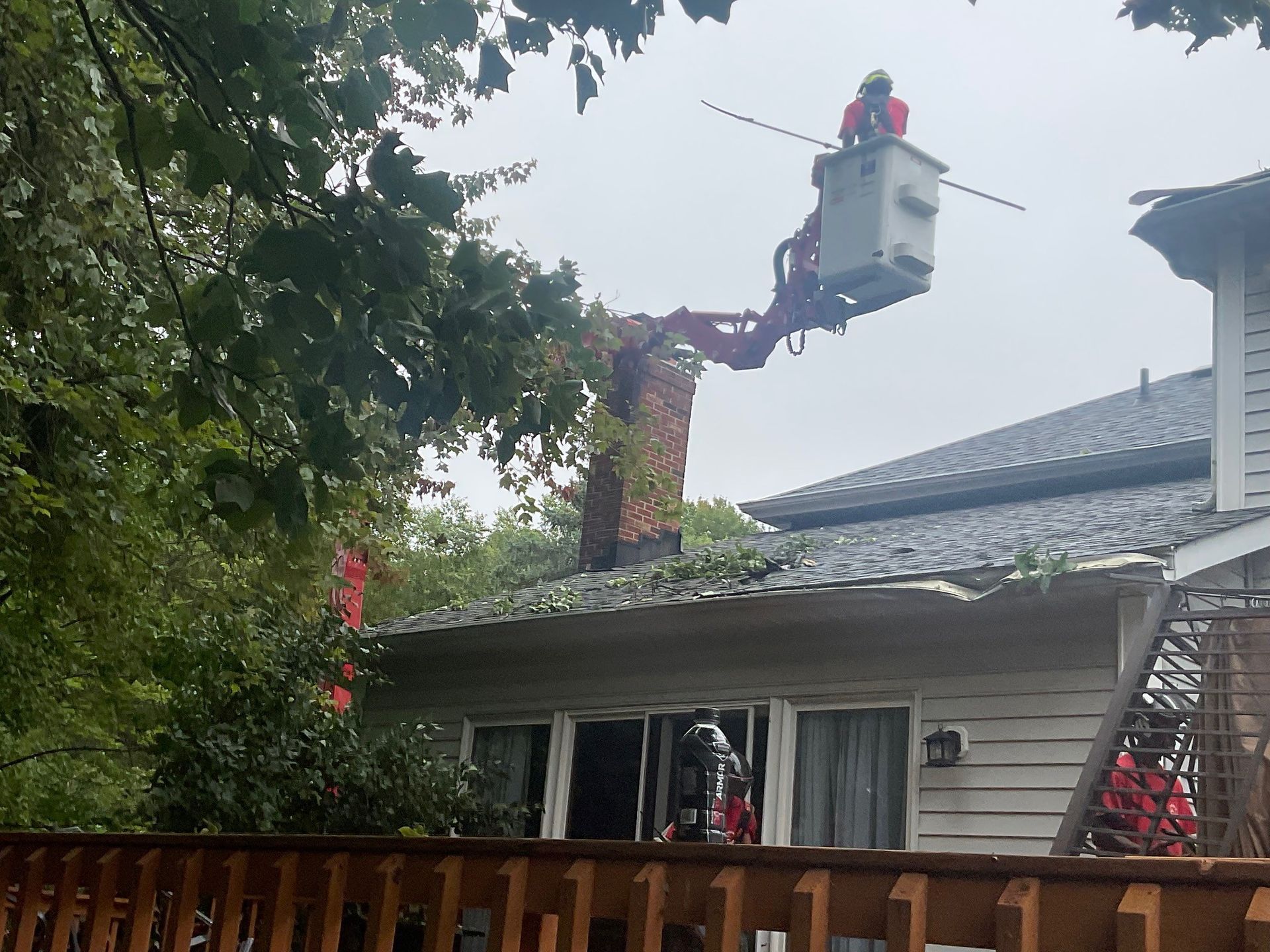 man doing tree removal in bucket truck