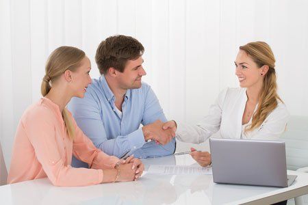 Young couple meeting with an employment lawyer