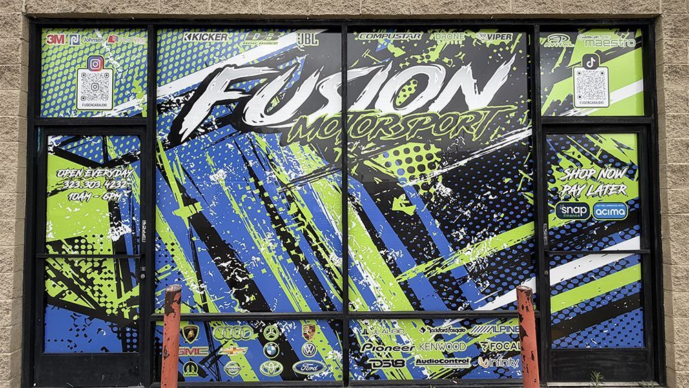 Colorful storefront window with a bold Fusion graphic in blue, green, black, and white