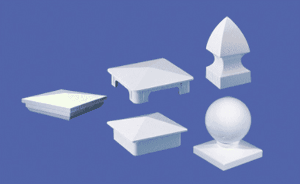 Five white fence post toppers with different designs against a blue background.